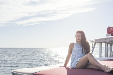 Young woman sitting on a boat - WESTF22228