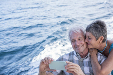 Happy couple on a boat trip taking a selfie - WESTF22239