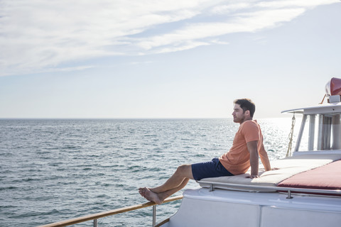 Young man sitting on a boat stock photo