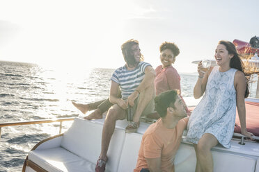 Happy friends on a boat trip having a drink - WESTF22263