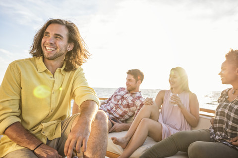 Happy friends hanging out on a boat trip stock photo