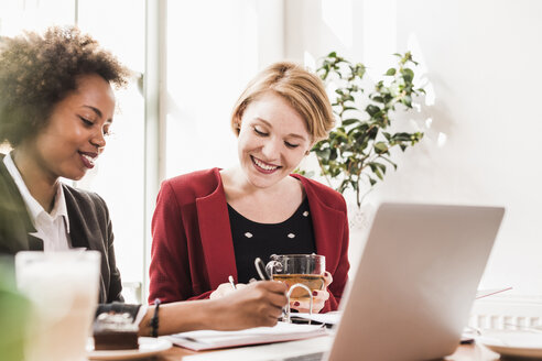 Zwei junge Frauen arbeiten in einem Cafe - UUF09445