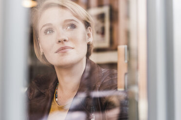 Young woman looking out of window - UUF09475