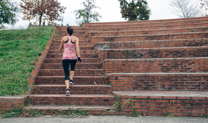 Woman running up stairs - DAPF00505