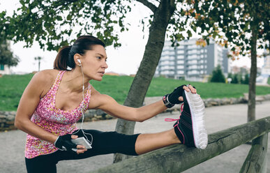 Woman stretching in a park - DAPF00508