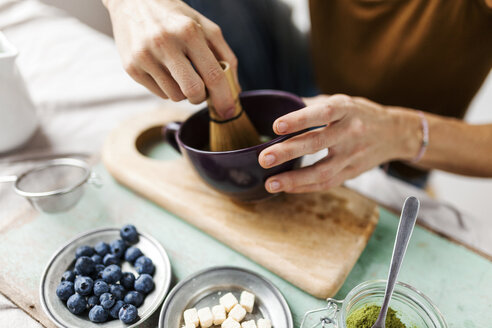 Woman preparing matcha latte at home - VABF00878