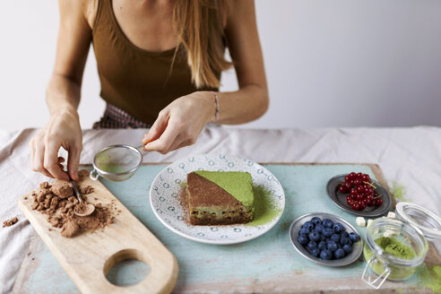 Woman preparing vegan matcha cake - VABF00891