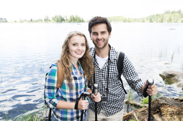 Young couple on a hiking tour at a lake - HAPF01179