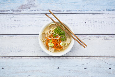 Bowl of miso soup with organic tofu, carrot noodles, parsnip, leek, glass noodles and parsley - LVF05702