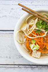 Bowl of miso soup with organic tofu, carrot noodles, parsnip, leek, glass noodles and parsley - LVF05706