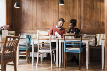 Young man and woman having a meeting in a cafe - UUF09501