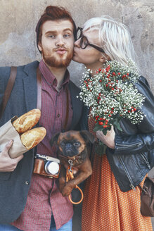 Young couple with dog kissing outdoors - RTBF00568