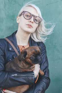 Portrait of young woman holding dog - RTBF00571