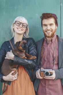 Portrait of smiling young couple holding a dog - RTBF00572