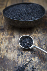 Mass and bowl of organic black sesame on dark wood - LVF05710