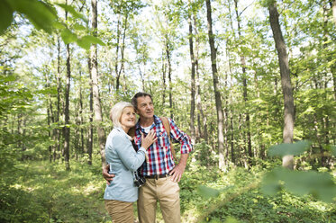 Senior couple watching something in the woods - HAPF01248