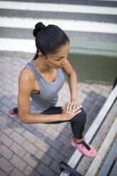 Woman stretching on a bench - GIOF01691