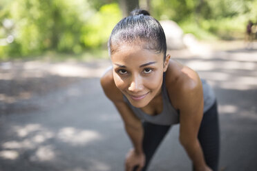 Portrait of confident female athlete relaxing - GIOF01713