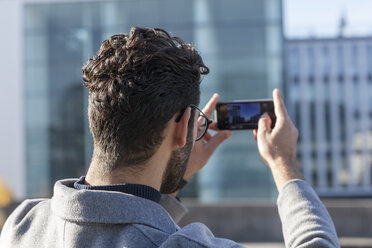 Back view of man taking picture with smartphone - TCF05241