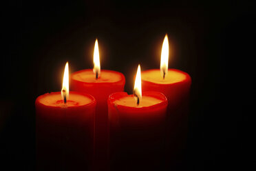 Four lighted red candles - JTF00791