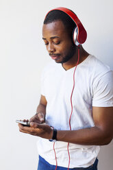 Young man with headphones and smartphone - VABF00938