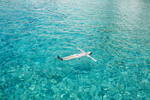 Greece, Milos, Woman floating on water stock photo