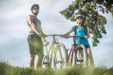 Young couple mountain biking in nature - ZEF11878