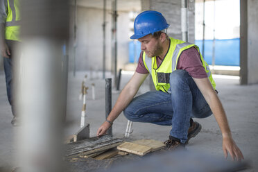 Construction worker on construction site checking work - ZEF11889