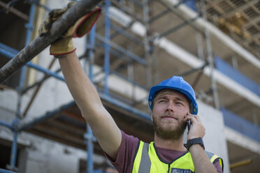 Construction worker on construction site talking on the phone - ZEF11891