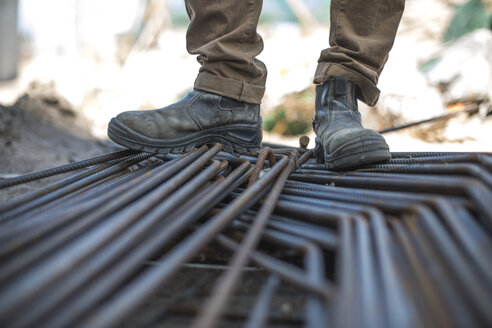 Construction worker standing on steel beams - ZEF11966