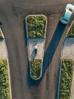 Businessman lying on traffic island - KNSF00796