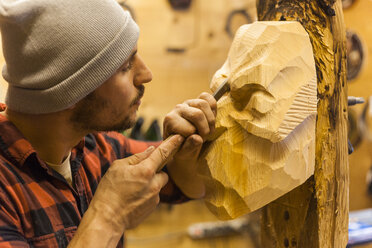 Wood carver manufacturing traditional Krampus mask - TCF05272