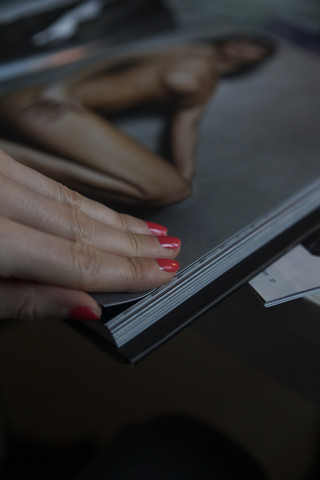 Frau mit Fotoalbum, das eine nackte Frau zeigt, lizenzfreies Stockfoto