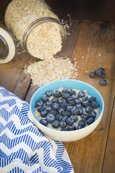 Bowl of overnight oats with blueberries on wood - LVF05753