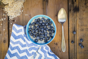 Bowl of overnight oats with blueberries on wood - LVF05755