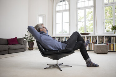 Relaxed mature man at home sitting in chair - RBF05374