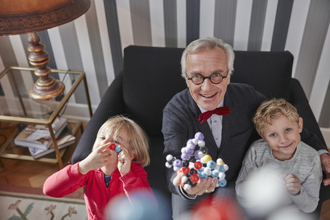 Grandfather and grandchildren with molecular model stock photo