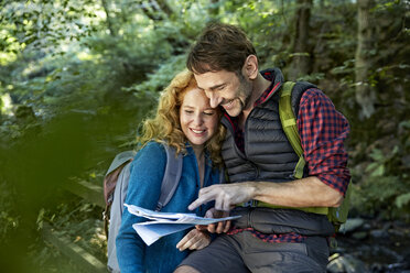 Hiking couple holding map - FMKF03341