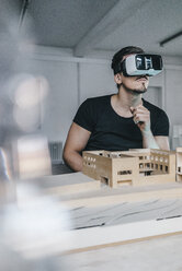 Man with architectural model and VR glasses - KNSF00832