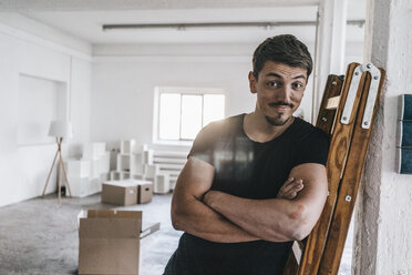 Portrait of confident man in empty loft - KNSF00846