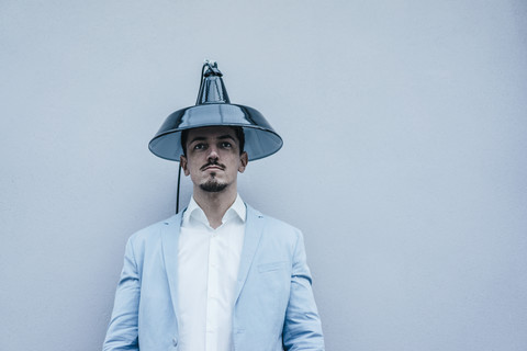 Man wearing lampshade as hat stock photo