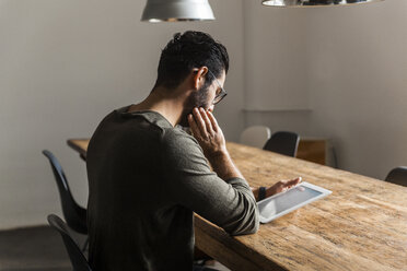 Young man using digital tablet in modern office - TCF05280