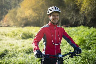 Mountainbiker im Wald, lächelnd - RAEF01624