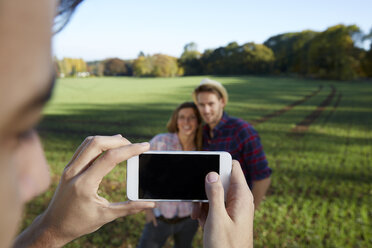 Cell phone picture of couple in the countryside - FMKF03356