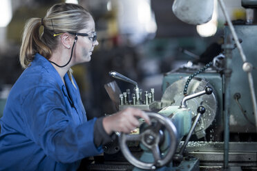 Woman operating machine in workshop - ZEF12127