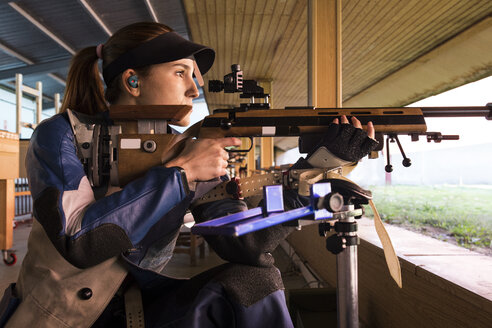 Frau mit einem Sportgewehr auf einem Schießstand - ABZF01693