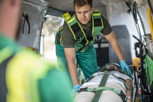 Paramedics moving car crash victim on stretcher - ZEF12177