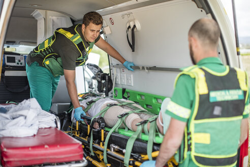 Paramedics moving car crash victim on stretcher - ZEF12178