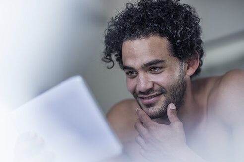 Portrait of smiling young man using tablet - ZEF12198