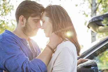 Couple embracing and kissing while on a road trip - WESTF22392